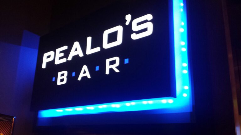 Pealo's Bar Red Wind Casino halo lit sign in Olympia, Washington.