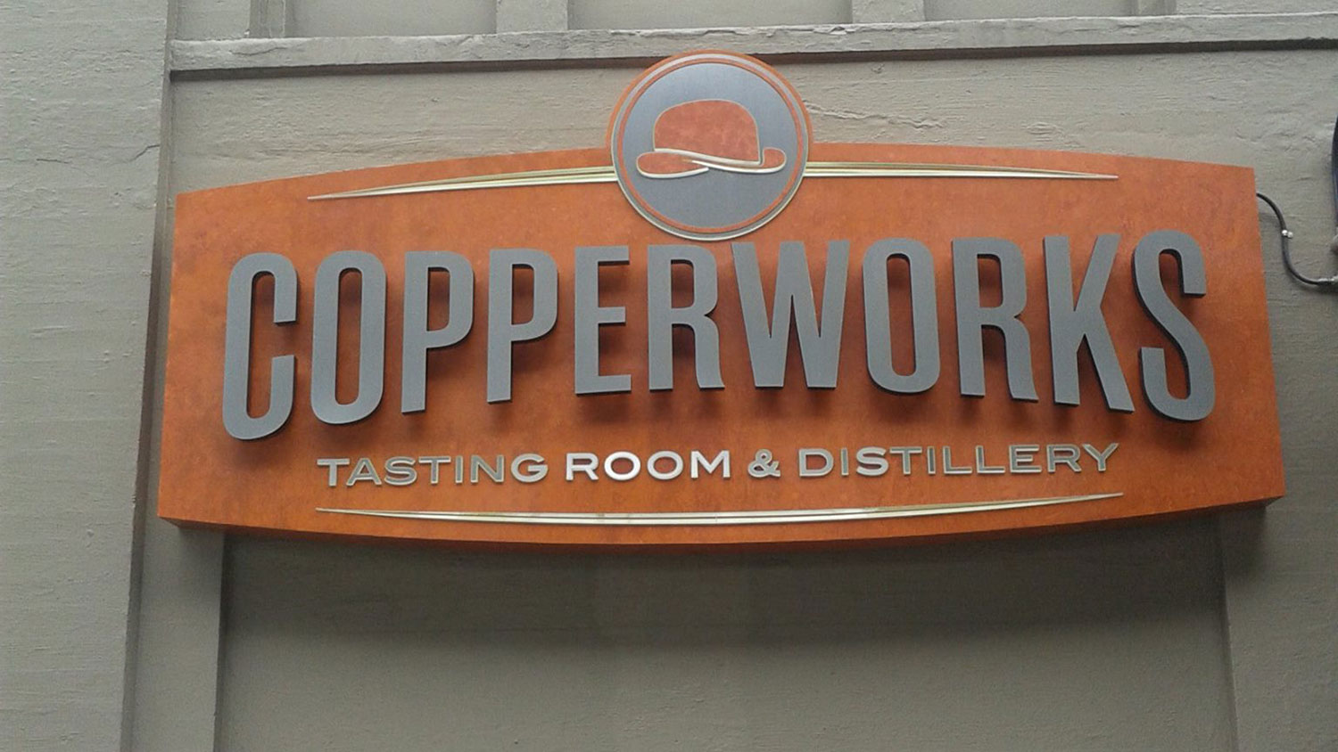 Copper metal pan sign for Copperworks Distillery by New Image Creative