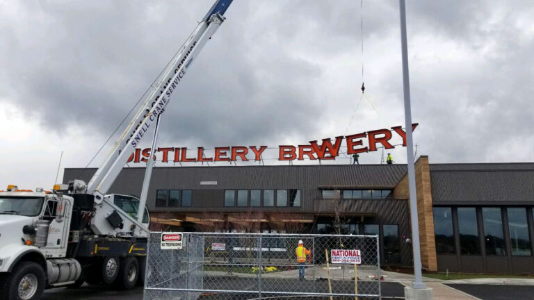 Sign installation with crane for Eagle 1 Distillery by New Image Creative